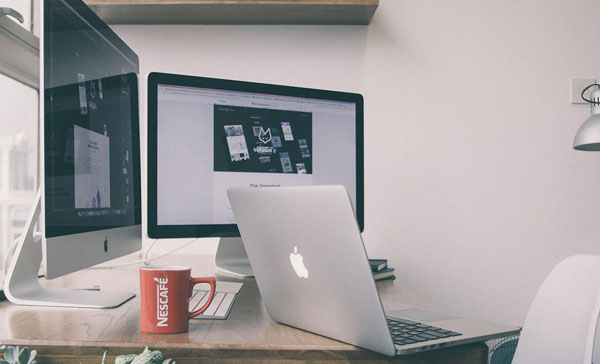 Computer Screen On a Desk. Improve your professional email writing skills.