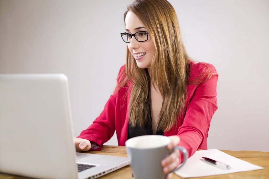 Adult woman working on a Laptop simplifying outlook email folders