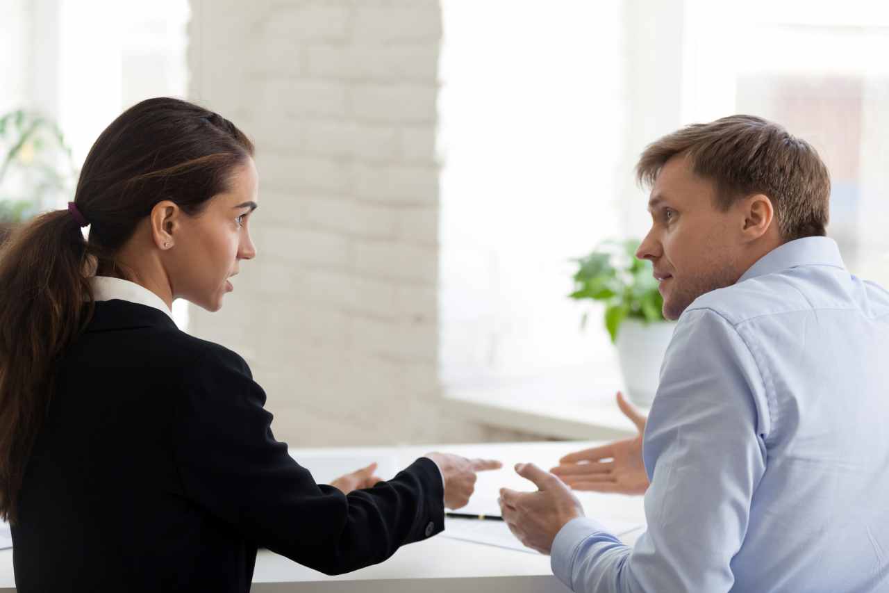 Woman and Man having a disgreement. Conflict at work.