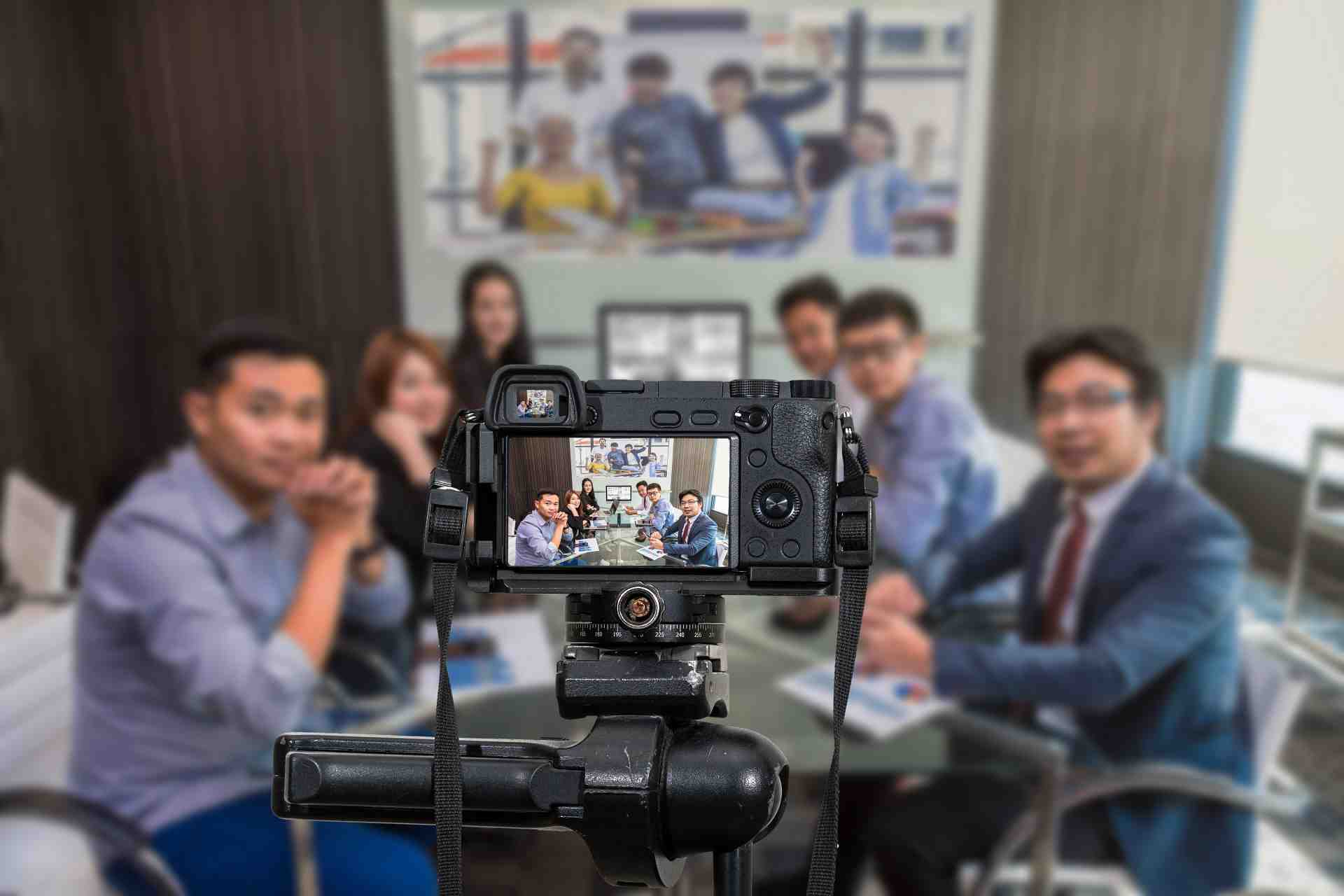 Professional digital Mirrorless camera with microphone recording video blog of Group of asian Business team having video conference,Camera for photographer or Video and Live Streaming concept. Record Microsoft Teams Meeting