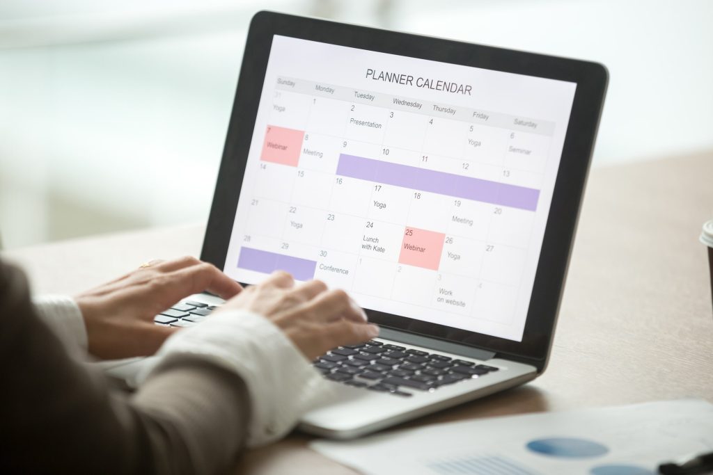 Lady using Calendar to plan her day- Open your outlook calendar by default